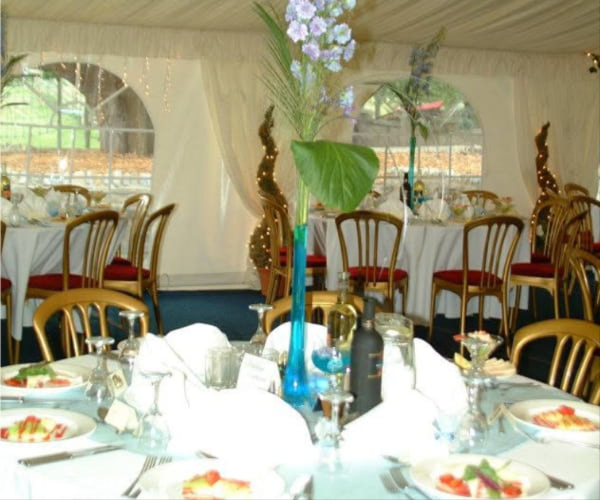 Wedding reception flowers created by Poppies Florist
